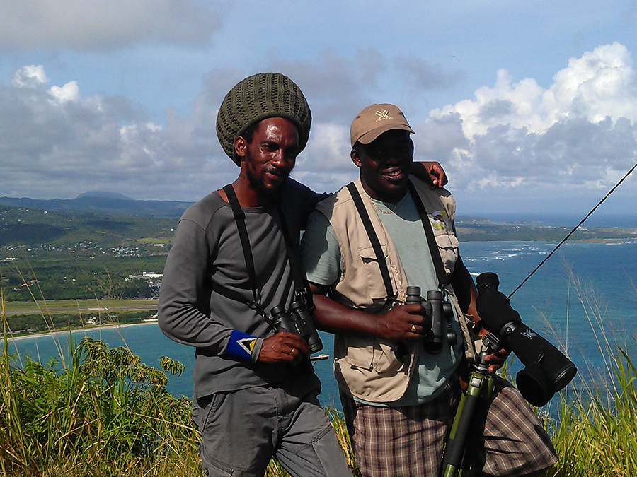 Adams Toussaint and a fellow Saint Lucian wildlife guide at a coastal viewpoint